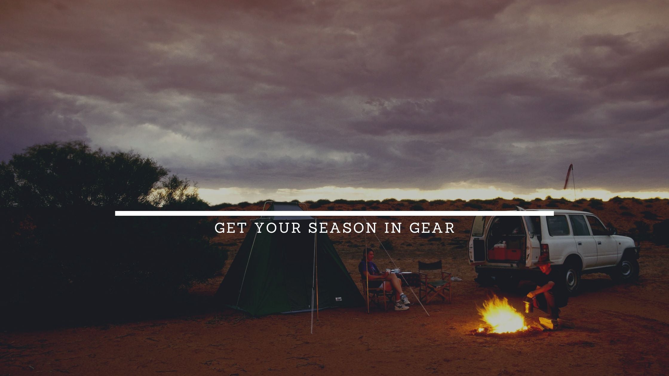 Camping scene with a vehicle, tent, and campfire under a cloudy sky.